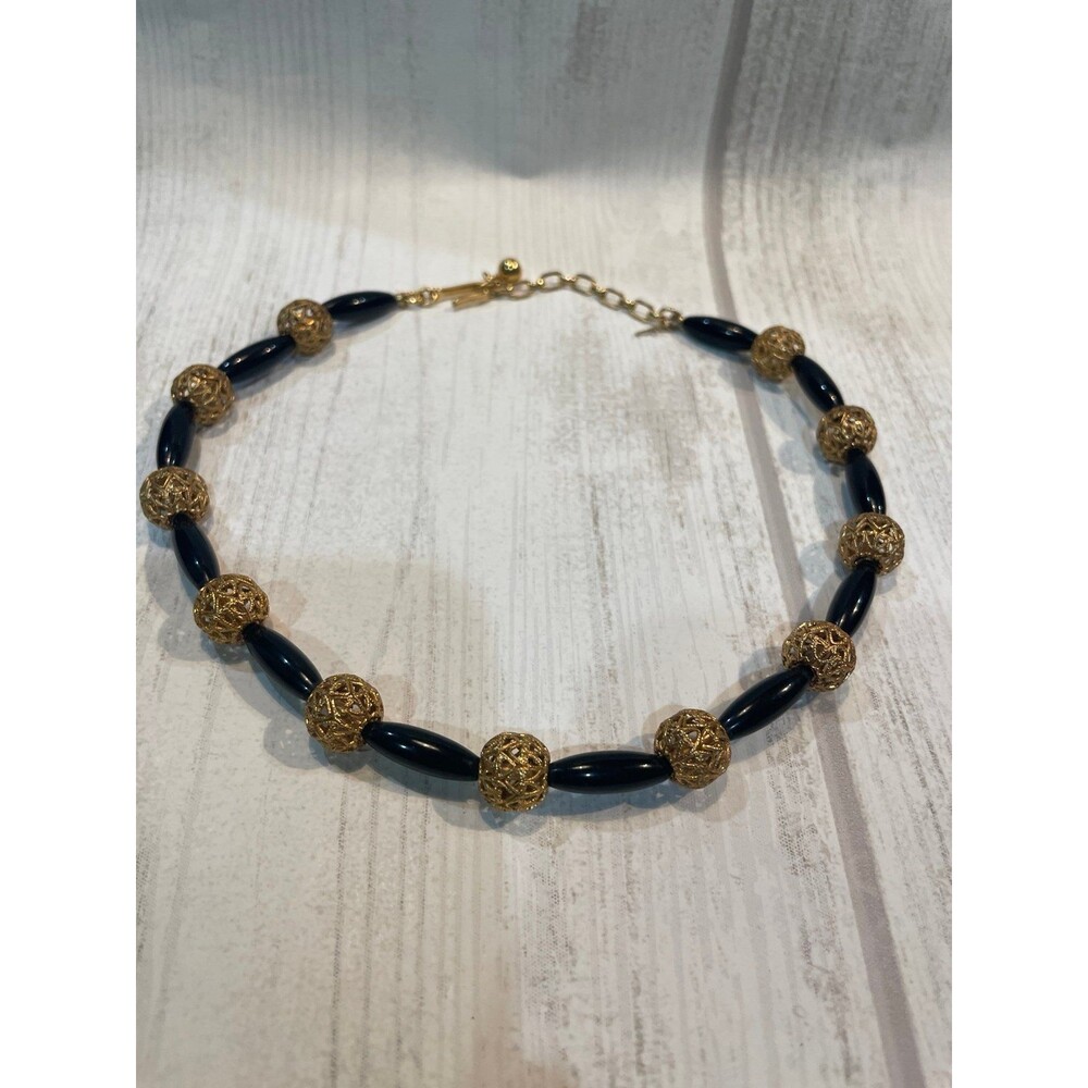 * Trifari Necklace black and gold beads. Gold clasp and emblem.
